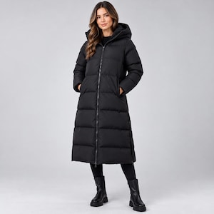 May include: A long, black, quilted puffer coat featuring a full-length front zipper, a hood, and long sleeves. The coat extends to the mid-calf and is worn over black leggings and black leather boots, creating a monochromatic look.