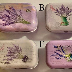 May include: Four small rectangular lavender-themed tin boxes with different designs. The boxes are all white with a lavender floral design and butterflies. The text on the boxes reads "Lavender" and "Bavandula".