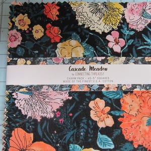 May include: A fabric charm pack with a floral design. The fabric features a dark background with colorful flowers in shades of orange, pink, yellow, and white. The text "Cascade Meadow" is visible on the packaging. Each square measures 5 inches.