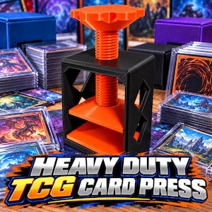 May include: A black and orange card press featuring a central threaded screw mechanism for applying pressure to trading cards. The device has a square frame with open sides and a top-mounted adjustment knob. Text reads: HEAVY DUTY TCG CARD PRESS.