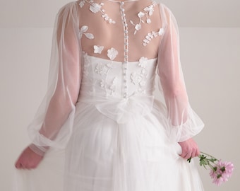Romantic soft tulle bishop sleeve wedding dress with whimsical floral embroidery and customizable design details.