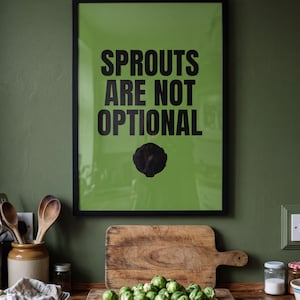 May include: A framed wall print with a bright green background and bold black text that reads SPROUTS ARE NOT OPTIONAL, featuring a black silhouette of a single Brussels sprout centered below the text in a simple black frame.