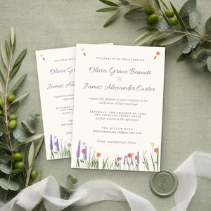 May include: A white wedding invitation card featuring the text Olivia Grace Bennett and James Alexander Carter, with colorful floral illustrations at the bottom and top. The card details the marriage ceremony at The Willow Barn in New York.