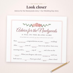 May include: A white fill-in-the-blank wedding game card titled Advice for the Newlyweds with pink floral illustrations at the top. The text includes instructions and blank lines for guests to write in words. A wooden pencil lies in the bottom right corner.