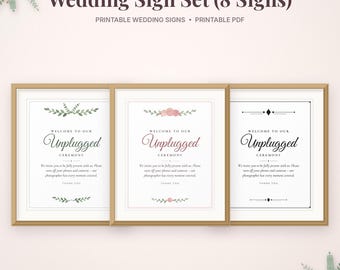 May include: A set of three framed wedding signs with the text "Welcome to our Unplugged Ceremony" and instructions to turn off phones and cameras. The signs feature floral and geometric accents in green, pink, and black ink on white paper.