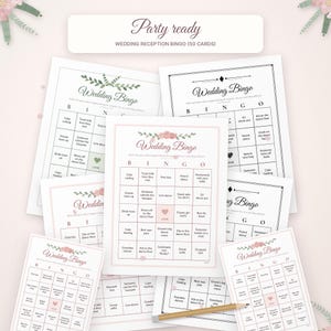 May include: A collection of white Wedding Bingo game cards with floral accents and black text, featuring a grid layout with various event prompts. A wooden pencil lies across the bottom cards. The top label reads Party ready WEDDING RECEPTION BINGO (50 CARDS).