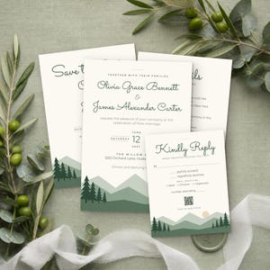 May include: A set of wedding stationery featuring cream-colored cards with dark green mountain and pine tree illustrations at the bottom. The text includes names Olivia Grace Bennett and James Alexander Carter, with details for a June 12, 2027 wedding.