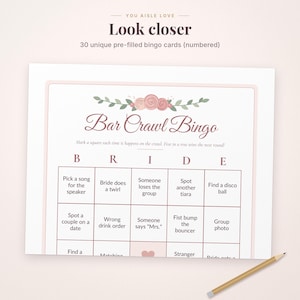 May include: A Bar Crawl Bingo game card featuring a floral header with pink roses and green leaves. The text reads Bar Crawl Bingo, Bride, and includes various prompts like Pick a song for the speaker and Spot another tiara. A pencil is included.