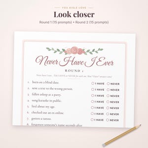 May include: A Never Have I Ever game card featuring a floral header with pink roses and green leaves. The text includes Round 1, 15 prompts, and a list of numbered statements with I HAVE and NEVER checkboxes for each. A wooden pencil lies nearby.