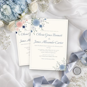 May include: A wedding invitation card featuring the names Olivia Grace Bennett and James Alexander Carter, decorated with blue and peach floral illustrations. The text includes the date, Saturday, the twelfth of June, and the location, The Willow Barn.