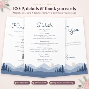 May include: A set of three white wedding stationery cards featuring dark blue mountain and pine tree illustrations at the bottom. The cards include RSVP, details, and thank you sections with text for Olivia and James, including a QR code.
