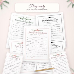 May include: A collection of white paper wedding game sheets featuring fill-in-the-blank templates titled Advice for the Newlyweds and Our Wedding Day with floral accents and a wooden pencil placed across the center of the stack.