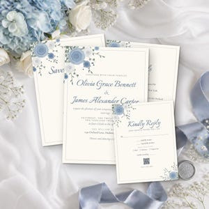 May include: A wedding invitation suite featuring cream-colored cardstock with blue floral illustrations. The text includes the names Olivia Grace Bennett and James Alexander Carter, along with event details and a Kindly Reply card with a QR code.