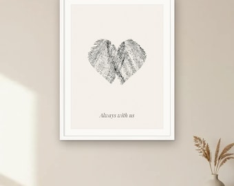 May include: A framed wall art print featuring a black ink heart shape formed by two overlapping fingerprints on a cream background. Below the heart, the text reads Always with us in a black serif font. The frame is white and rectangular.