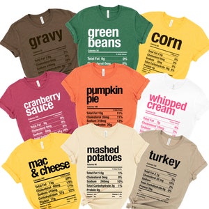 May include: Ten different t-shirts with Thanksgiving food names and nutritional information printed on them. The shirts are in various colors, including brown, green, orange, red, white, yellow, and beige.