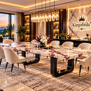May include: A dining room featuring a large rectangular table with a white and red marble top and black U-shaped legs. Six cream-coloured upholstered chairs with black legs surround the table. A wall displays the text KingofinlaY with a crown icon.
