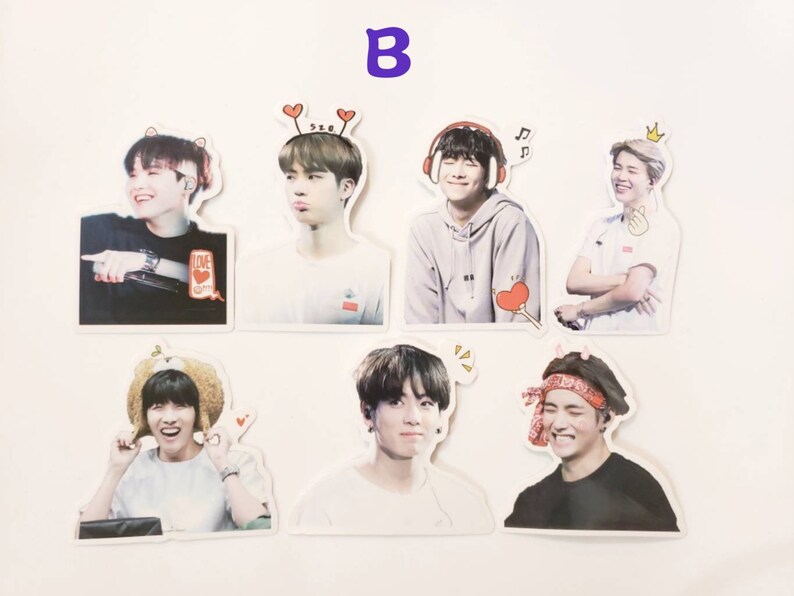 May include: Set of seven stickers featuring different members of a K-pop group. Each sticker has a white background and features a close-up photo of a person with a cartoon-like accessory on their head. The stickers are printed with high-quality images and are perfect for decorating laptops, water bottles, and other personal items.