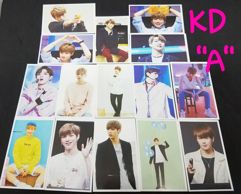 May include: A collection of 12 photo cards featuring a young man with different hairstyles and outfits. The cards are printed on white cardstock and have a glossy finish. The text "KD "A"" is written in pink on a white background.