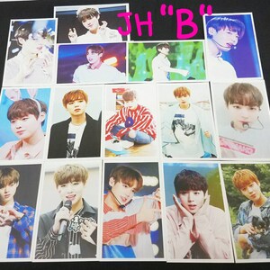 May include: A collection of 12 photo cards featuring a young man with brown hair. The cards are printed on white cardstock and feature various poses and expressions. The cards are all the same size and shape. The text "JH "B"" is written in pink letters on a white background at the top of the image.