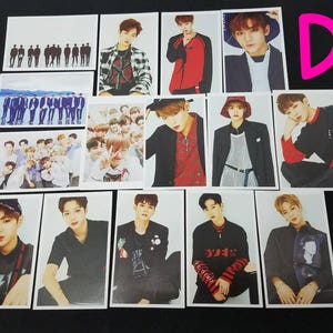 May include: A set of 12 photo cards featuring a K-pop boy band. The cards are printed on white cardstock and feature various images of the band members. The cards are all the same size and shape.