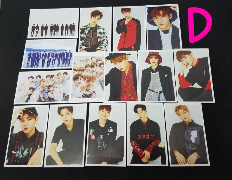 May include: A set of 12 photo cards featuring a K-pop boy band. The cards are printed on white cardstock and feature various images of the band members. The cards are all the same size and shape.