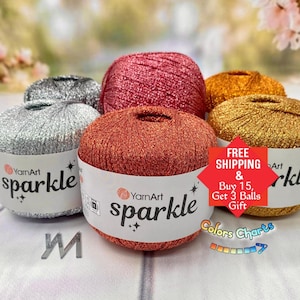 May include: Five round balls of YarnArt Sparkle yarn in metallic silver, red, copper, and gold tones. Each ball features a white paper label with the brand name YarnArt and the product name sparkle printed in black text with star icons.