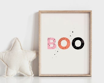 May include: A framed print with the word "BOO" in colorful, patterned letters. The letters are pink, orange, and black. The background is white with small black stars.