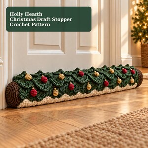 May include: A cylindrical crochet draft stopper featuring a dark green layered leaf design, a white base, and brown ends. It is decorated with small red and gold spherical ornaments. The text reads: Holly Hearth Christmas Draft Stopper Crochet Pattern.
