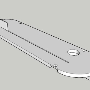 May include: A light gray table saw throat plate featuring an elongated rectangular shape with rounded ends, a central longitudinal slot, a circular opening at one end, and a small vertical fin protruding from the opposite end surface.