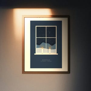 May include: A framed wall art print featuring a dark blue background with a window graphic showing a snowy night landscape and two lit candles on the sill. The text KYYNTILÄ TWO CANDLES 2 DECEMBER is printed in white at the bottom of the illustration.