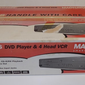 May include: A Magnavox MWD2206 DVD Player & 4 Head VCR combo unit in its original packaging. The box is white and red with product details and a graphic of the device. Features include DVD, CD-R/RW playback, component video out, and S-video output.