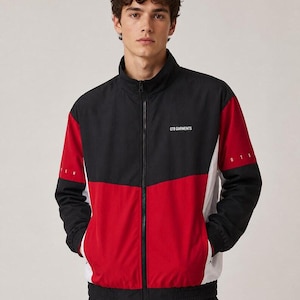 May include: A color-blocked zip-up track jacket featuring black, red, and white panels. The chest displays the text 078 GARMENTS in white. The sleeves have red and black sections with white accents, and the jacket includes a high collar.