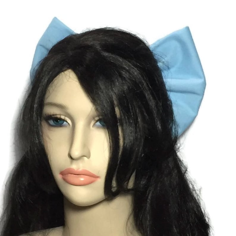 May include: A light blue fabric bow headband. The headband is worn on a mannequin with long black hair.
