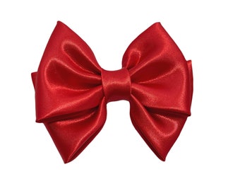Red satin bow for women or girls. Handmade on red satin fabric. Red bow on barrette, alligator clip, or nylon headband. Red hair bows