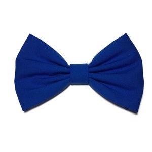 May include: A royal blue bow tie made of fabric. The bow tie is tied and ready to wear.