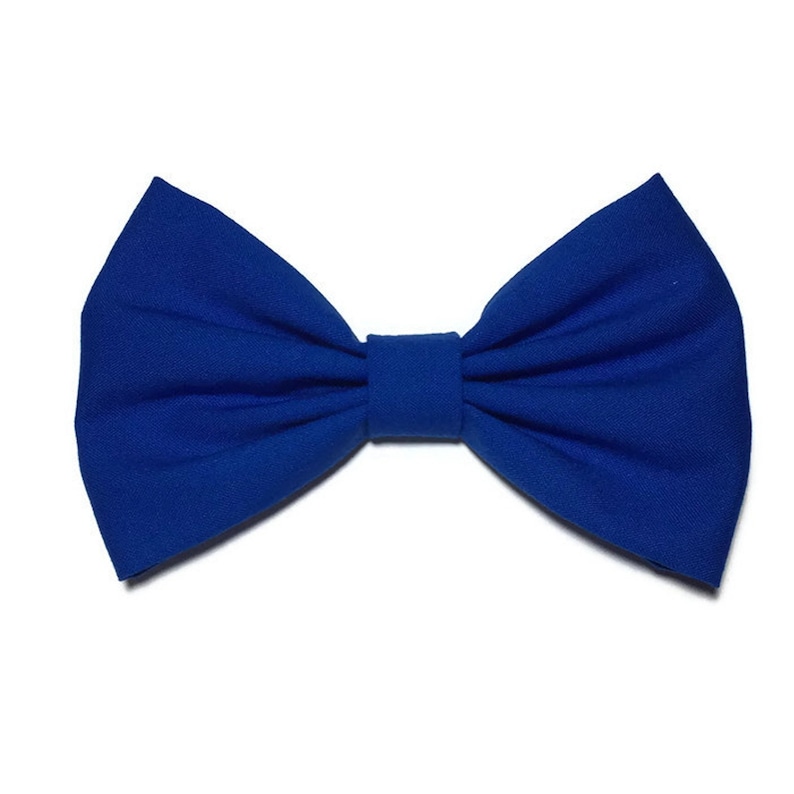 May include: A royal blue bow tie made of fabric. The bow tie is tied and ready to wear.