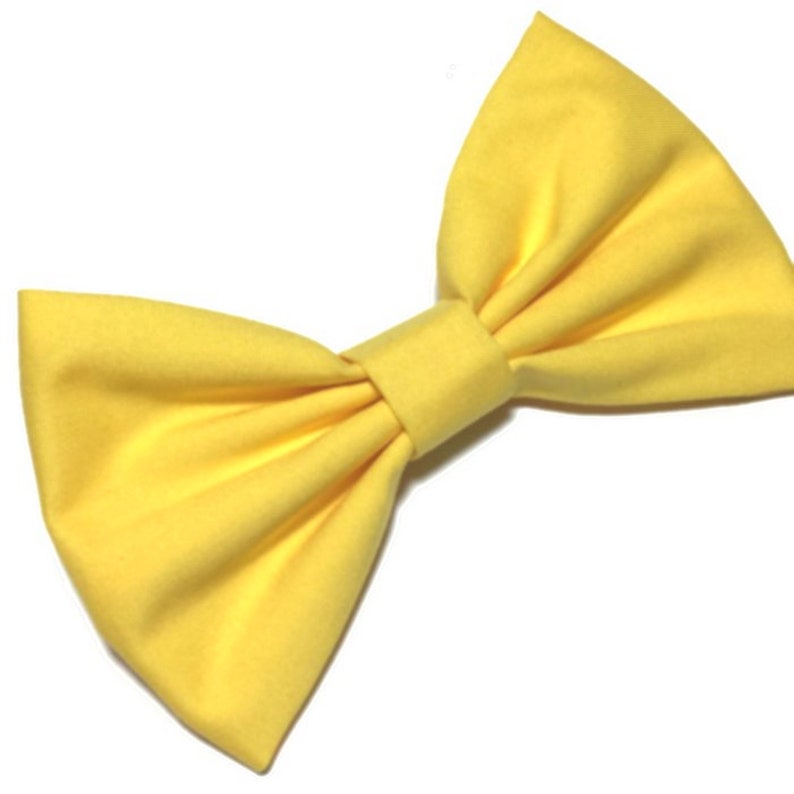 May include: A large yellow fabric bow.