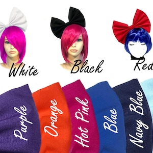 May include: A set of ten fabric hair bows in various colors, including white, black, red, purple, orange, hot pink, blue, navy blue, and light blue. The bows are shown on mannequins with different colored wigs.