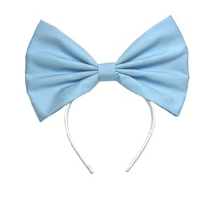 May include: A light blue fabric bow headband with a white plastic headband.