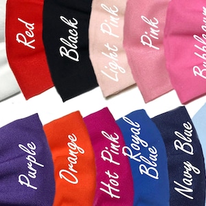 May include: A collection of fabric swatches in various colors, including white, red, black, light pink, pink, bubblegum, purple, orange, hot pink, royal blue, navy blue, and light blue. The swatches are arranged in two rows, with the top row showing the lighter colors and the bottom row showing the darker colors.