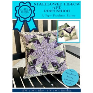 May include: A paper foundation pattern for a starflower pillow and pincushion. The pillow is 16 inches wide by 16 inches high and the pincushion is 6 inches wide by 6 inches high. The pillow is made with purple, green, and white fabric. The pincushion is made with white fabric with a green and white floral design.