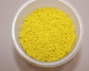 Handcrafted lemon-yellow polymer paste vermicelli sold in sachets