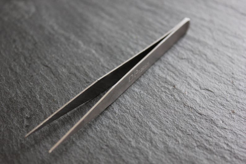 Metal clip to end right called clamp tweezers