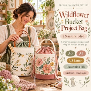 May include: Two cylindrical fabric project bags with drawstring closures. One bag features a green and yellow wildflower print with brown leather handles. The other bag displays a large pink floral pattern with a solid pink base and fabric handles.