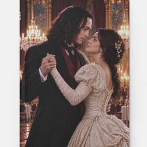 May include: A hardcover book cover featuring a scene of two individuals dancing in a ballroom. One wears a black tailcoat with a red vest, and the other wears a cream-colored lace gown with pearl accents. The background shows chandeliers.