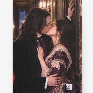 May include: A book cover featuring a couple in historical attire kissing. The person on the left wears a black coat and purple vest, while the person on the right wears a purple dress with lace trim. A small square barcode with the text 12345678 is visible.