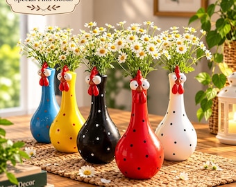 May include: Five ceramic vases shaped like chickens, each featuring a different base color of blue, yellow, black, red, or white with black polka dots. Each vase has a chicken head with large eyes and a red comb, filled with white daisies.