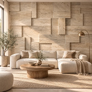 May include: A beige sectional sofa with several throw pillows and a textured throw blanket, positioned in front of a wall covered in rectangular travertine stone tiles. A round wooden coffee table sits on a woven rug.