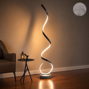 May include: A tall, black, spiral-shaped floor lamp with an integrated LED light strip that emits a warm glow. The lamp features a continuous, twisting design that rises from a circular base, creating a vertical, illuminated sculptural form.