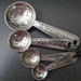 Vintage Metal Measuring Spoons With Raised Flower Design